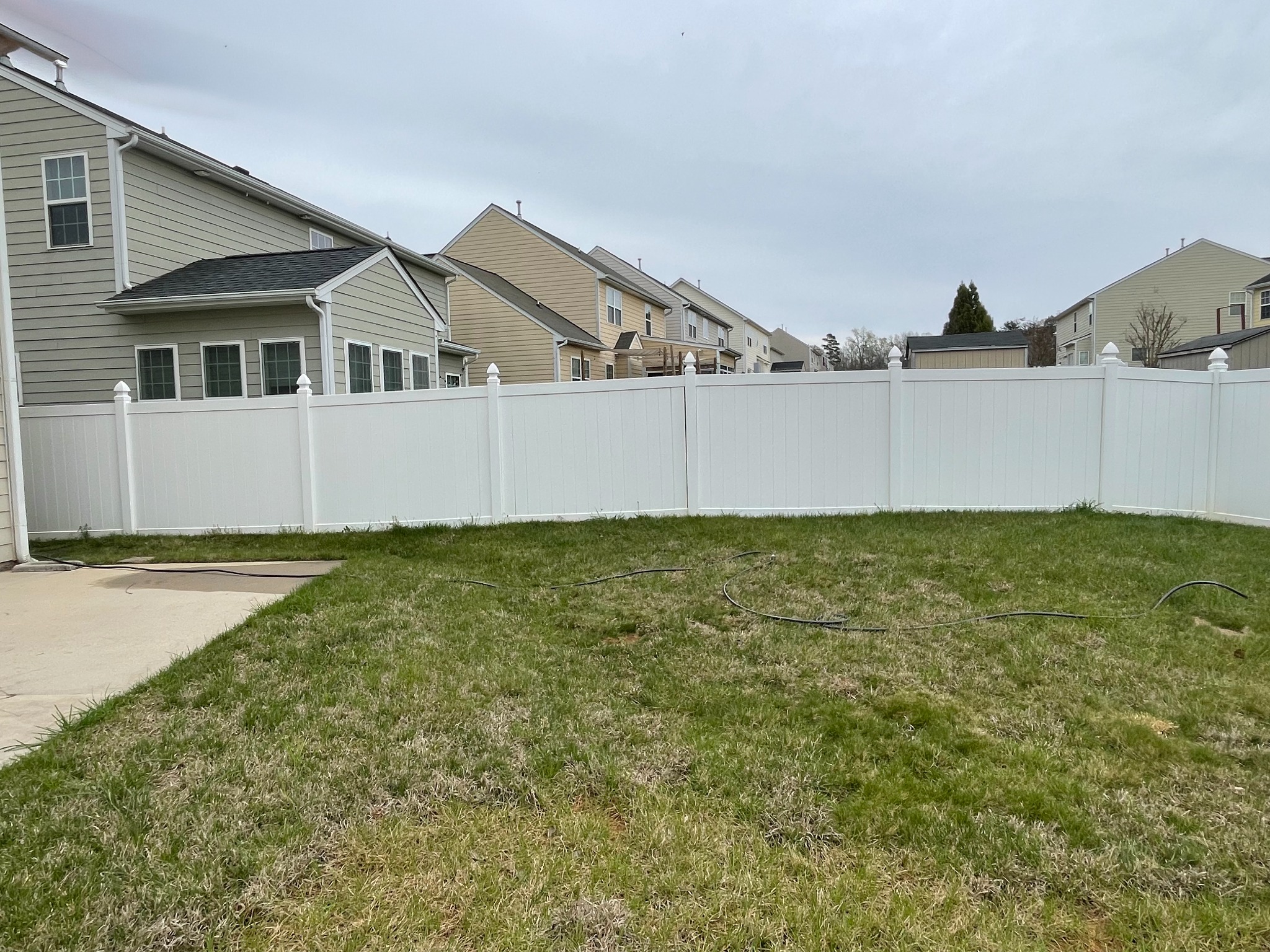 Vinyl fence after pressure washing looking cleaner and brighter
